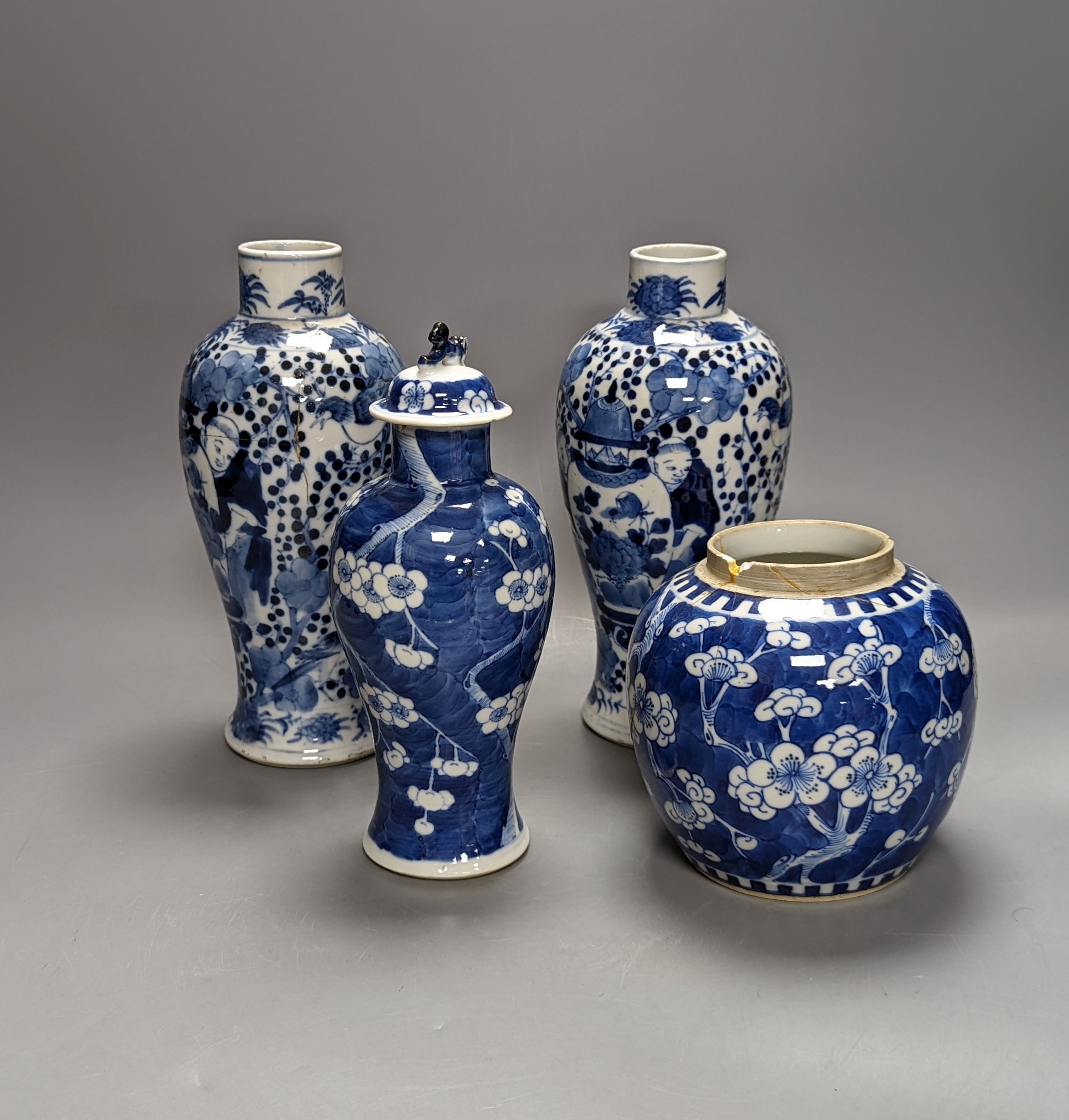 A pair of 19th century Chinese blue and white vases, a prunus vase and cover and a similar jar (4), pair of vases 24 cms high.